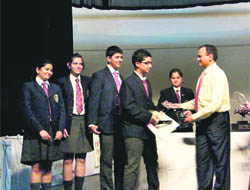 The winning team of Lawrence School, Sanawar, receives the trophy from Pradeep                             N Dhoot, president, Videocon Industries, at Kasauli on Saturday.