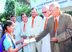 Governor NN Vohra gives away a Rajya Puraskar to a girl guide in Jammu on Sunday.