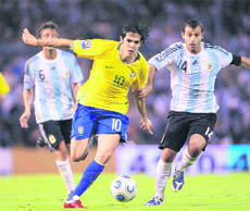 Brazils midfielder Kaka (L) vies for the ball with Argentinas Javier Mascherano during their  match on Saturday.