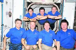 These seven international astronauts and cosmonauts take a few minutes from a busy agenda to pose for a portrait on the International Space Station on Friday, where theyre spending more than a week with a second group of visitors in summer 2009, accomplishing joint activities with the STS-128 Discovery crew. 