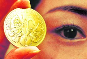 A gold coin is displayed during a photo opportunity at the Ginza Tanaka store in Tokyo