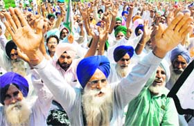 Members of the Bharatiya Kisan Union (Ekta) protest in favour of their demands outside the office of Regulatory Commission in Chandigarh