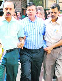 NCB zonal director Sunil Kumar Sekhri being taken out of the district courts in Chandigarh