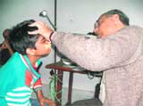 Dr Sanjay Sachdeva examining a patient at a free ENT camp organised by the Kangra-based Vivekananda Kendra at Gopalbagh