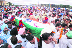 The body of former Punjab Chief Minister Harcharan Singh Brar wrapped in the National Flag being carried to the cremation ground of Sarai Naga village in Muktsar district on Monday. 