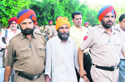 Balbir Singh Bhootna, alleged terrorist, being taken to a court in Ludhiana on Monday. 