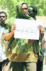 Sudanese journalist Lubna Hussein walks out of the court after a final hearing in her 'trousers' case in Khartoum on Monday.