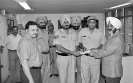 Punjab DGP PS Gill and IG Parag Jain honour cops for nabbing 14 truckers evading sales tax.