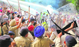 The police uses water cannons at members of the BKU during a protest near the Sector 16 cricket stadium in Chandigarh