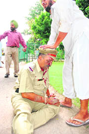 A cop, who was injured by an angry mob, being consoled by a farmer.  