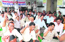 Power corporation workers hold protest in Dehradun on Tuesday.