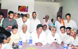 AICC observer Avtar Henry (centre) talks to mediapersons in Fatehabad 