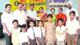 Raikot Lions Club president Mukesh Gupta hands over a cheque to seven orphan students . 