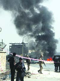 Soldiers secure the site of the car bomb, outside the entrance to the military airport, in Kabul