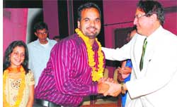 Amit Bhatia, president, Panjab University campus students council, being congratulated by Vice-Chancellor.