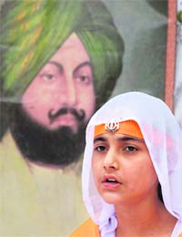 A girl participates in a Bhakti Geet competition organised to pay tributes to Sardar Dyal Singh Majithia in Karnal