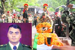 A senior Army officer lays a wreath on the body of Major Akash Singh (Inset) who laid down his life foiling an infiltration bid in Poonchs Mendhar sector on Wednesday.