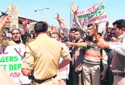 Members of the All Jammu and Kashmir Dailywagers Association ( Forest Department) demonstrate in Srinagar on Wednesday, demanding the regularisation of their services. At least 10 protesters were arrested during the protest. 