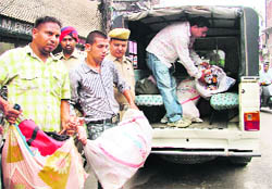 Pirated CDs being seized from Mata Rani Chowk in Ludhiana on Thursday.