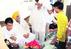 A 13-year-old boy serves cold drink to Manish Tewari and others at Jagraon on Thursday. 