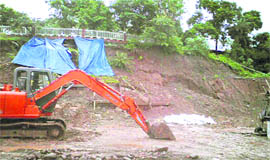 The caved-in part of the dug-up hillock, which led damage on the road at Mata Mansa Devi temple in Panchkula on Friday.