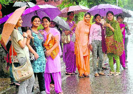 Girls enjoy light showers in Sector 42, Chandigarh.