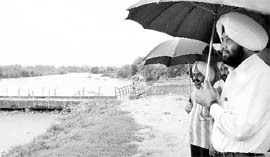 Deputy Commissioner, Patiala, Deepinder Singh inspects Ghaggar river after heavy rain on Friday.