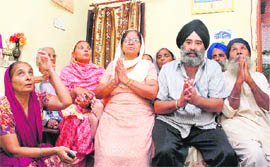 Families of 1984 riot victims pray for justice during a gathering at Phase XI, Mohali, on Friday.