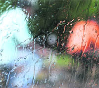 Cyclists as seen through the windscreen of a car during rain in Ludhiana on Friday.