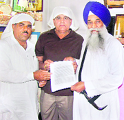 The Jathedar of Akal Takht (right) receives a memorandum from representatives of the Samaj Bachao Morcha in Amritsar on Friday. 