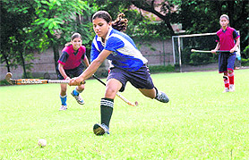 Players in action at the District Women Hockey Tournament in Dehradun on Saturday.