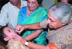Chief Minister Sheila Dikshit with health minister Kiran Walia administers polio drops to children in New Delhi on Saturday.