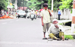 A leper begs on a road in Dehradun. 