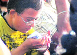 A challenged boy sips water at the inaugural ceremony of the regional parents meet in Ludhiana on Saturday.
