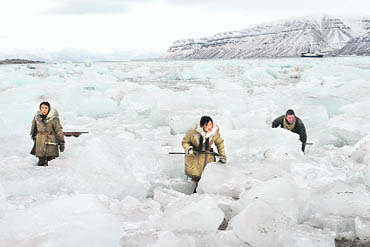 Human triangle thaws beneath the heavy skies of the Arctic in Far North