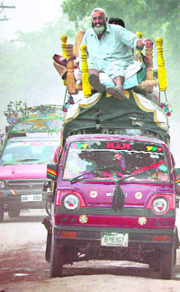 Residents travel on the roofs of vehicles stacked with their belongings in Bara district while fleeing Pakistans Khyber Agency on Saturday.