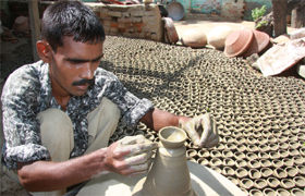 A potter busy making diyas (earthen lamps) in Bathinda on Sunday. 