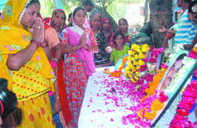 Relatives of the victims who lost their lives in the Gaffar Market blast last year, pay homage to their loved ones during a 'Shradhanjali Sabha,' organised by All India Anti-Terrorist Front at Beadonpura in Gaffar Market, New Delhi on Sunday. 