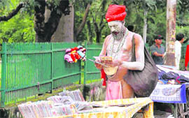 A sadhu looks at compact discs at a rehri near Gandhi Park, Dehradun, on Sunday.