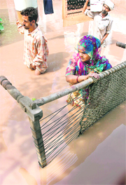 People shift belongings after their houses were flooded following a breach in the Ghaggar at 