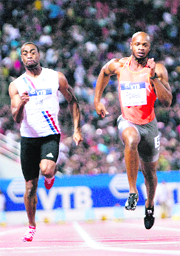 Tyson Gay of the U.S. (L) and Jamaica's Asafa Powell  