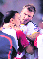 Los Angeles Galaxys David Beckham(R), grapples with FC Dallas Daniel Hernandez during a scuffle after their Major League Soccer match on Saturday. 