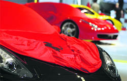Sports cars of Italian car manufacturer Ferrari are covered during preparation work for the international car show "IAA" in Frankfurt on Monday. The world's biggest auto show starts with its media days on Tuesday and will run until September 27.