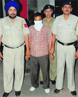 Accused Surinder Singh in police custody at the Mani Majra police station on Monday. 