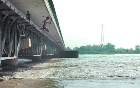 Children jump into the Yamuna which shows signs of receding in New Delhi