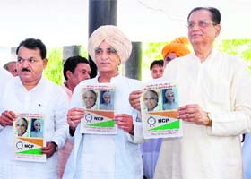 (Right) Govind Ram Adik, general secretary of the Nationalist Congress Party, releases his party manifesto in Karnal