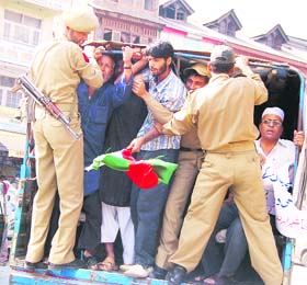 Policemen arrest Jammu and Kashmir Liberation Front activists at Hari Sing High Street in Srinagar