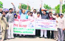 Visually challenged take out a protest march against the state government in Ludhiana.