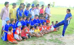 A coach gives tips to the budding football players at Andloo.