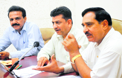 Kuldeep Sharma (L) addresses the press 